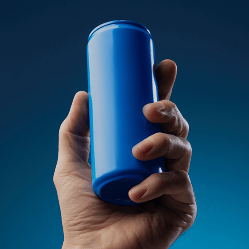 A hand holds a blue canned drink